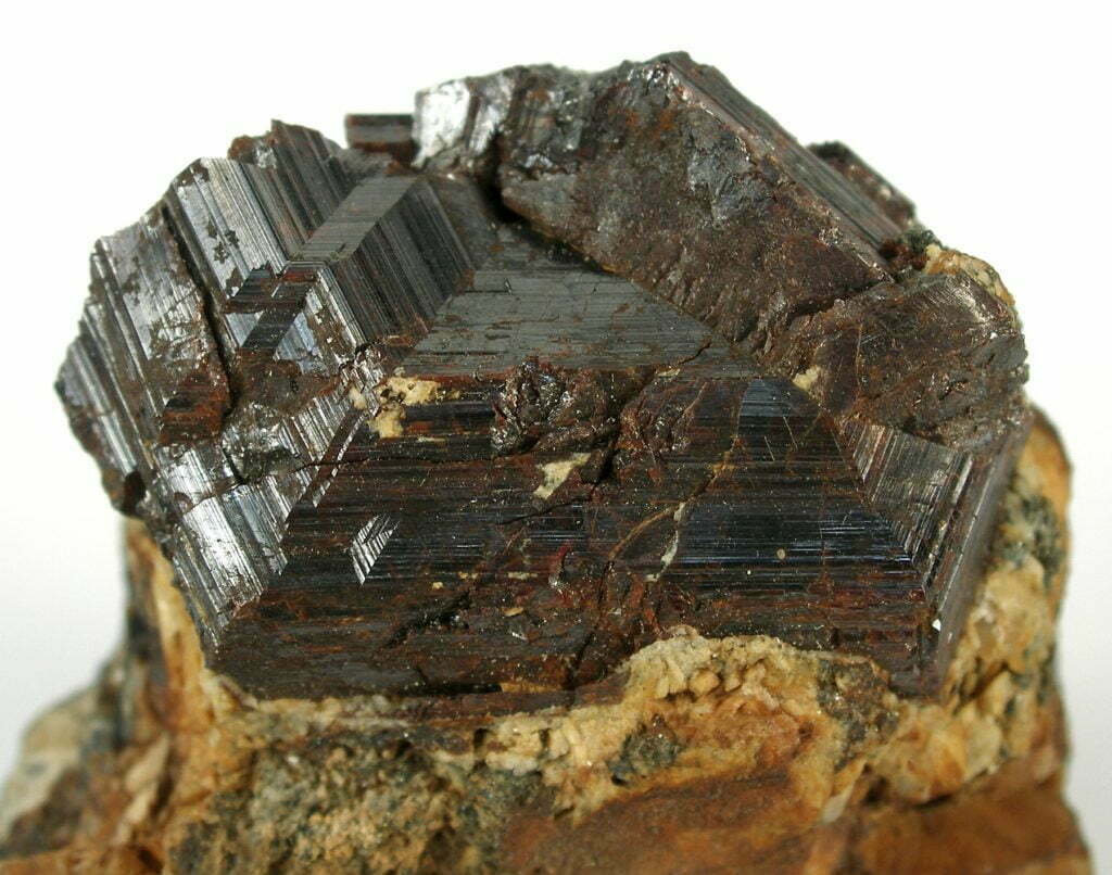 A well-sized matrix specimen hosting at its peak a sharply twinned, very geometric, rutile crystal