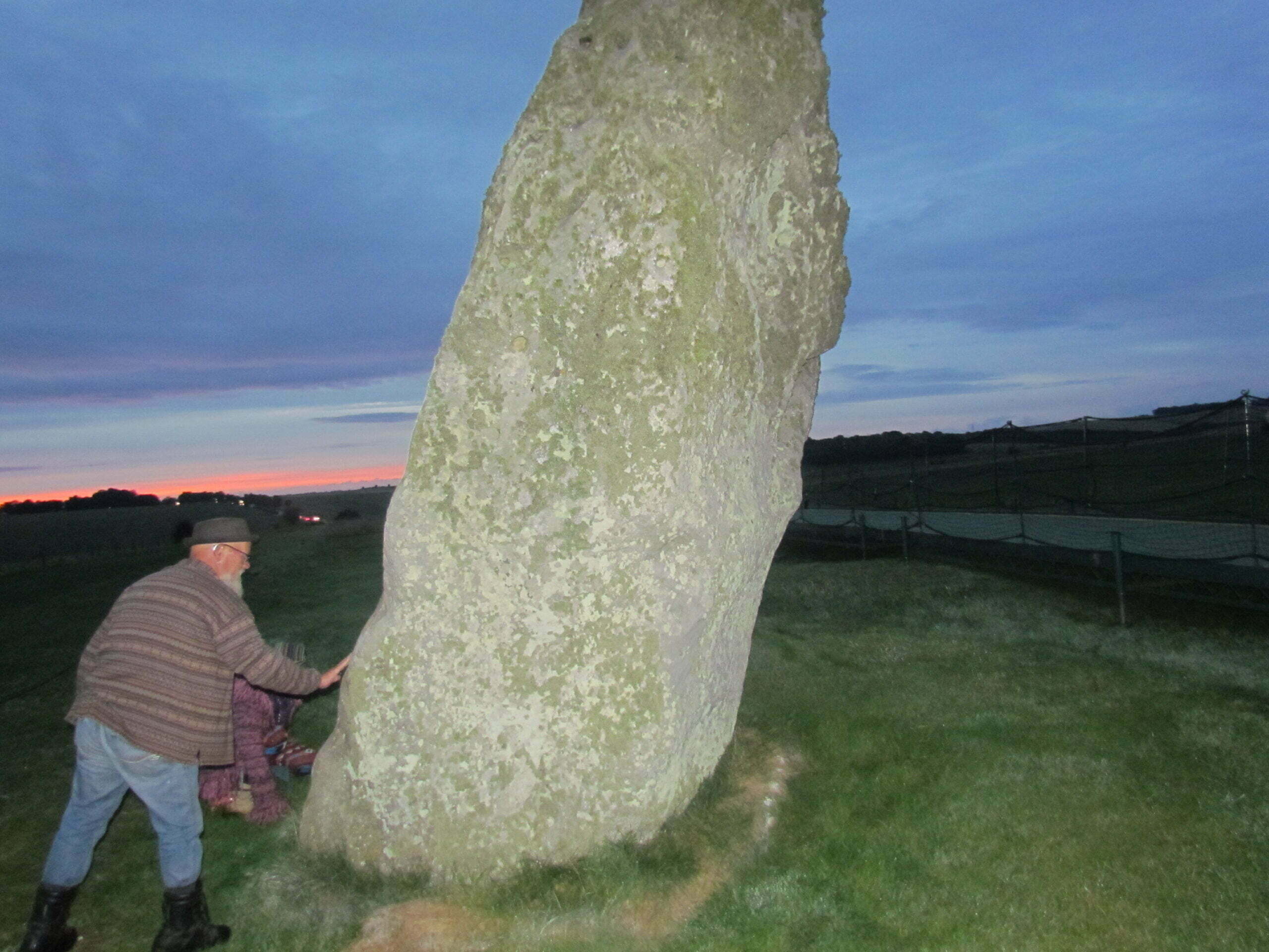 Two geezers saying goodbye to a friend, scattering his ashes below The Heel Stone