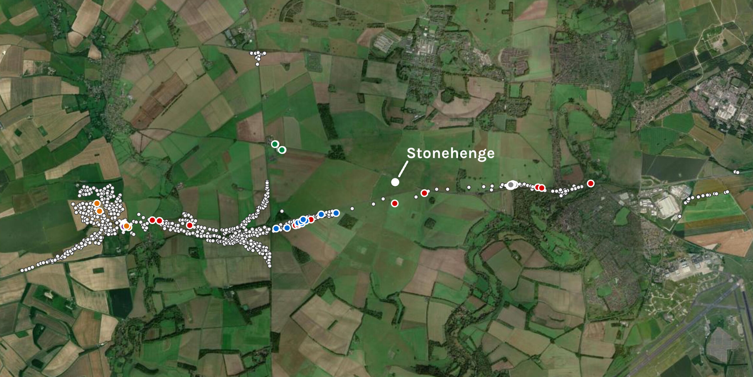 Satellite map of the Stonehenge landscape with several hundred small white dots marking investigation locations